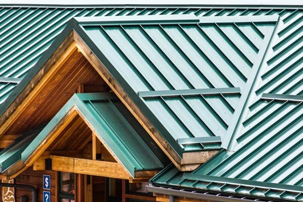 Green metal roof on wood-framed building