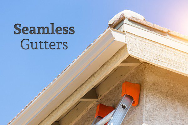 The top corner of a house with seamless gutters beside the words "Seamless Gutters"