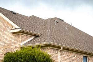 Up close detailed photo of new shingles on brick home