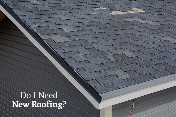 The broken roof of a gray house above the words do i need new roofing