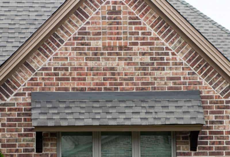 Close-up of nice roof awning on a red brick house.