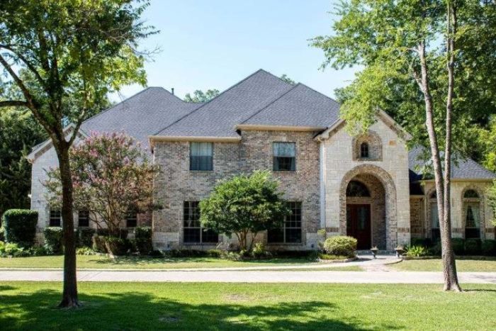Street view of a nice two-story brick home with a new roof.