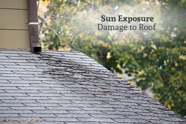 Damage to shingles on the roof of a home, with the words, sun exposure damage to roof