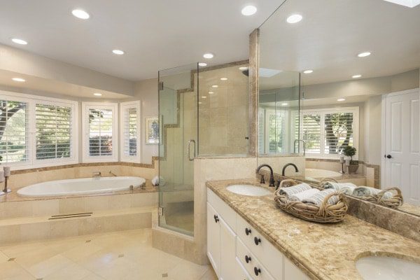 A beautiful bathroom with open spaces, a spa-tub, and a walk-in shower.