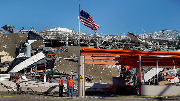 An American Flag waving above the debris of a Home Depot store in Dallas that was ravaged by a tornado