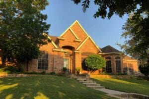 Street View Of A Beautiful Home With A New Roof