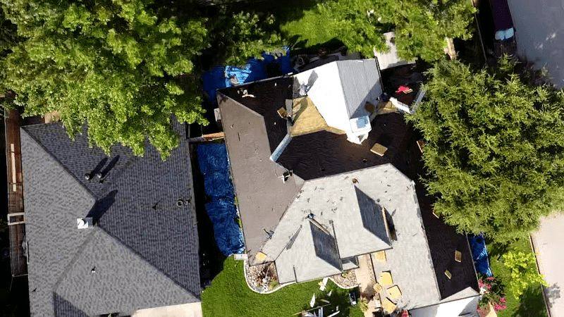 Aerial View Of A New Residential Roof Being Installed On A Home