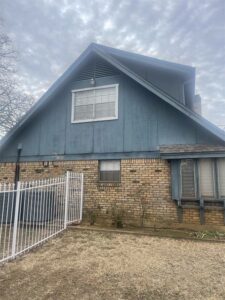 a home with warn down blue siding