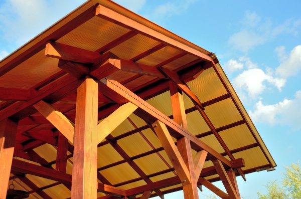 A picture of an arched pergola that is covered.