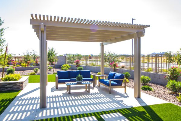 A picture of a free standing pergola over a sitting area.