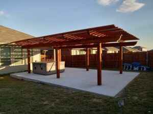 a brand new slab of concrete with a new pergola ontop